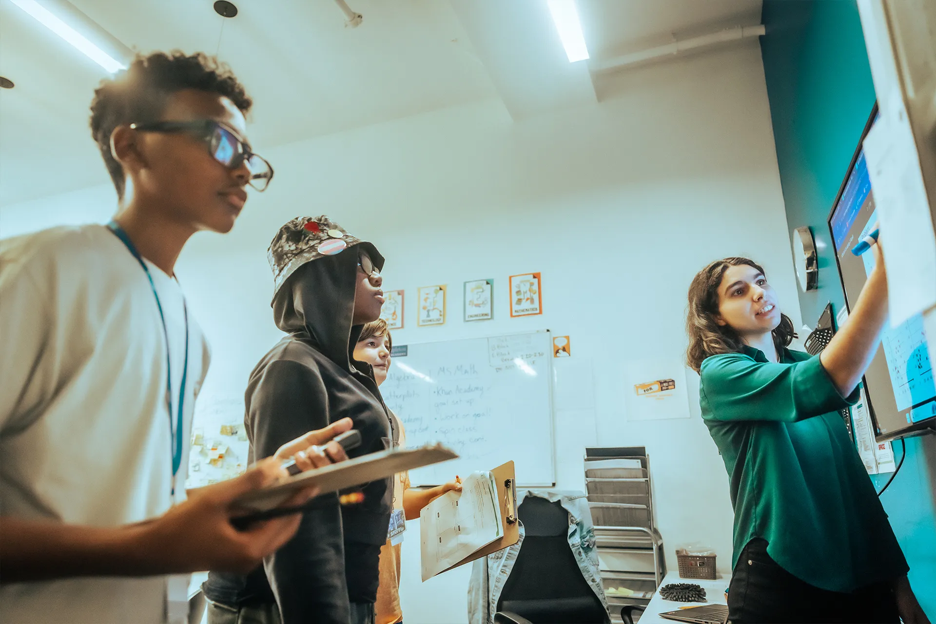 Templeton Academy students working on a math problem with their teacher